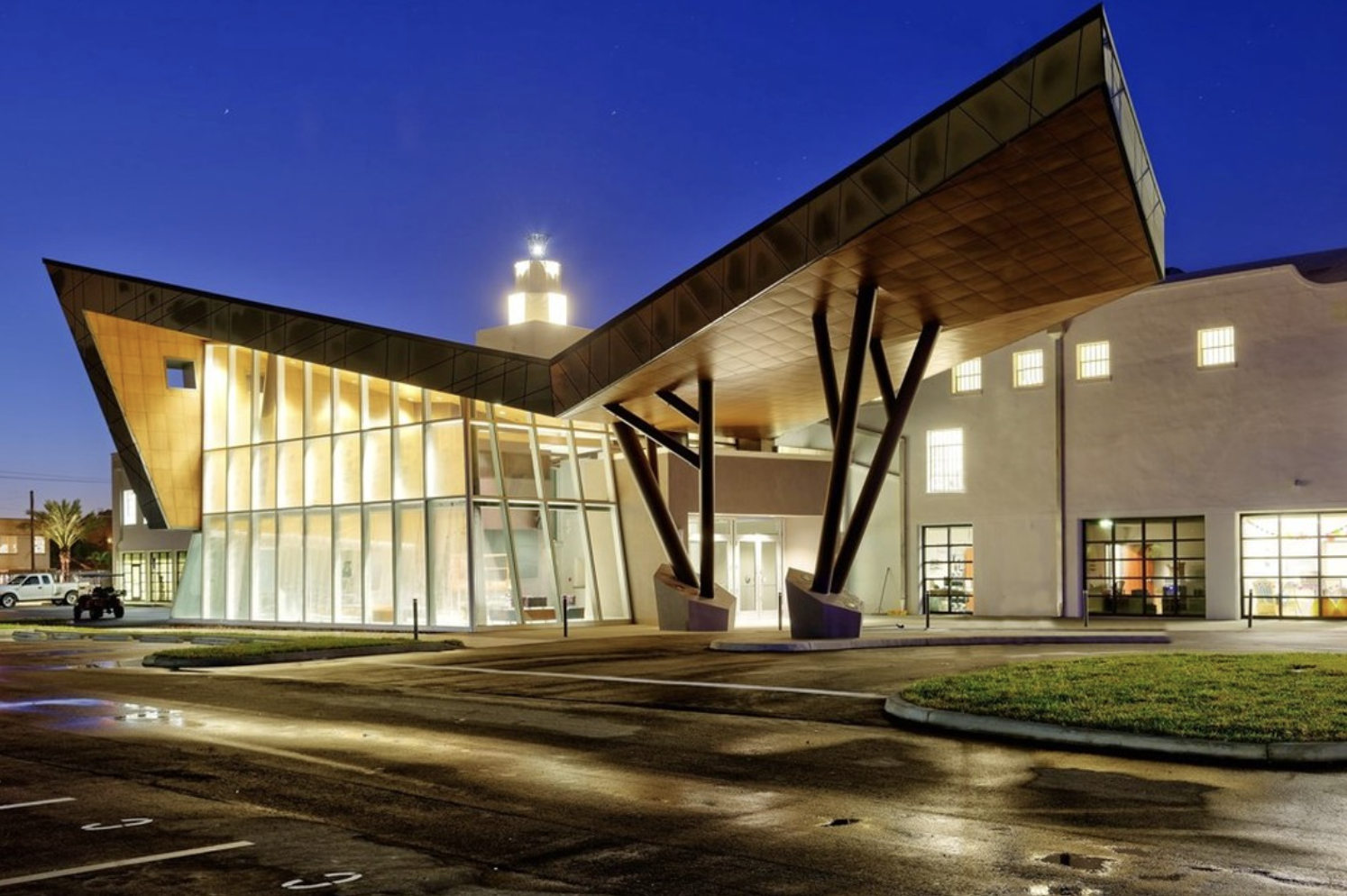 The venue's angular facade glowing at night under a deep blue sky